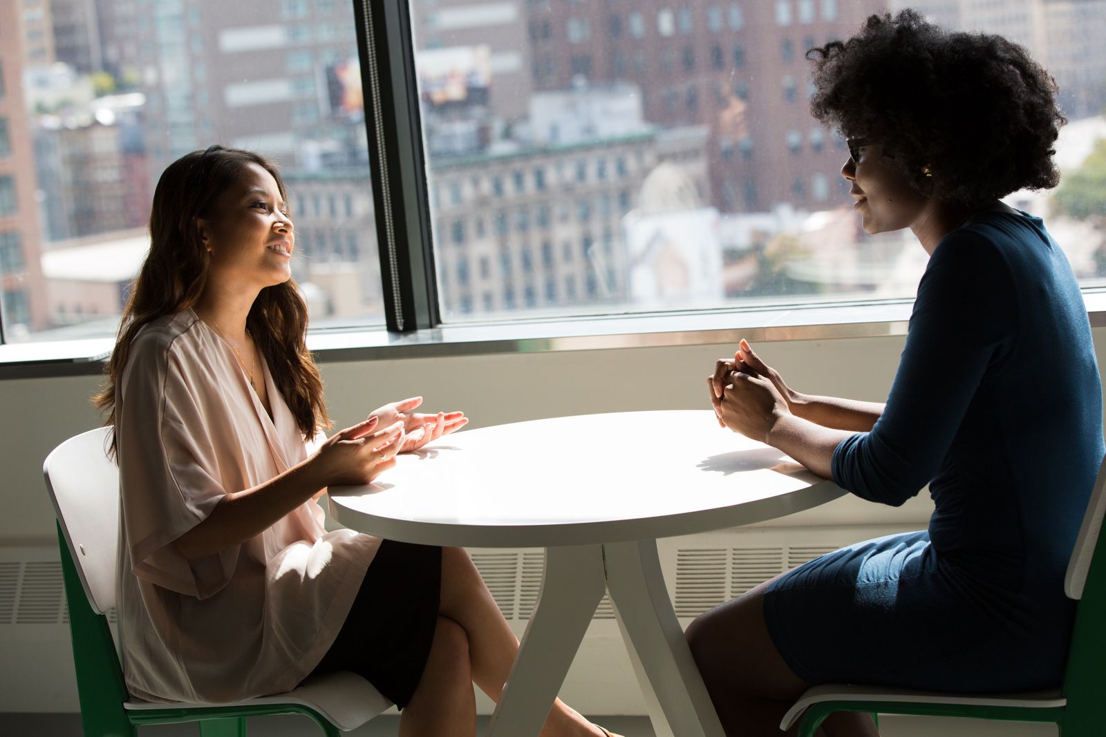 Two professionals in conversation at a desk